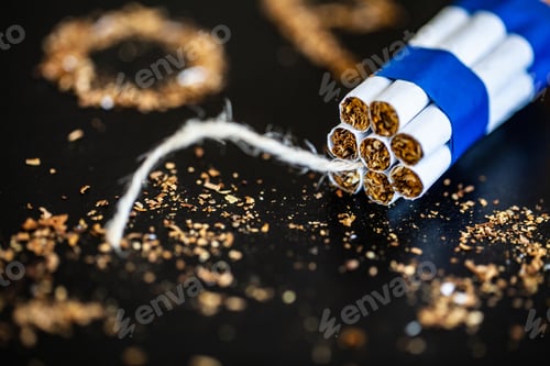 Preview: Stop smoking concept on background with broken cigarettes. Heap of cigarettes. No smoking
