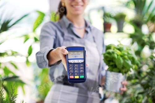 Preview: Professional florist holding a POS terminal
