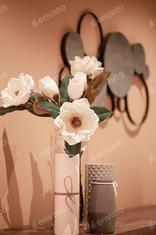 Preview: Interior design with a vase and artificial flowers on the table.