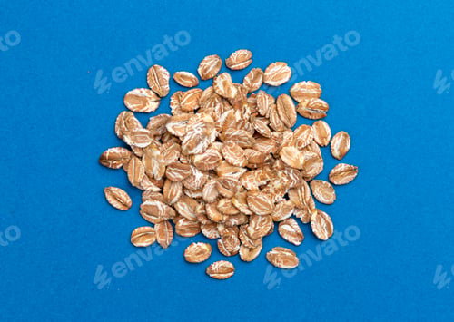 Preview: Pile of Oat flakes on blue background, top view