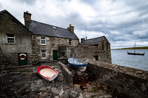Preview: Low angle view of old houses near the sea in Shetland, Scotland
