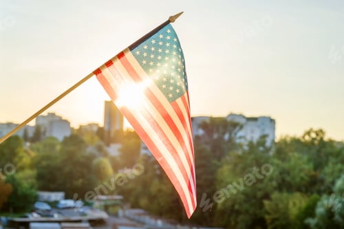 Preview: American flag from the window on sunset background