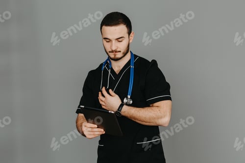 Preview: Portrait of a friendly doctor. Isolated on gray