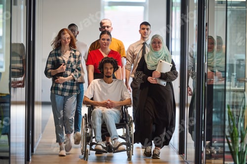 Preview: A diverse group of young business people congregates within a modern startup's glass-enclosed office