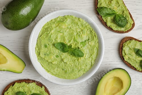 Preview: Flat lay composition with guacamole, sandwiches and avocados on white wooden table