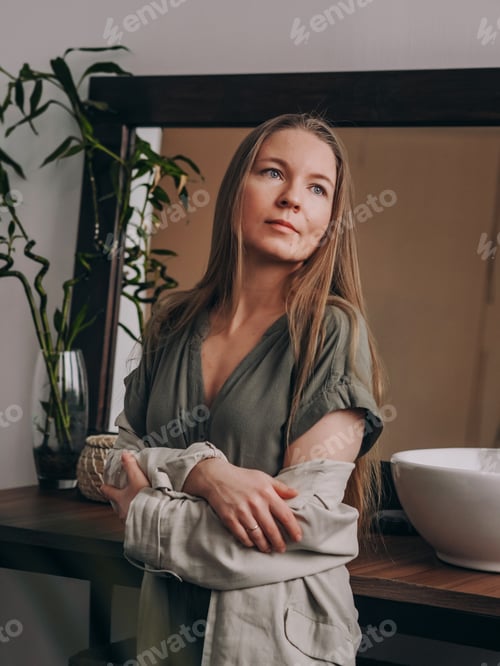 Preview: Woman in Green Dress Poses Inside Home