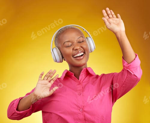 Preview: Happy, music headphones and black woman dance in studio isolated on a yellow background. African pe