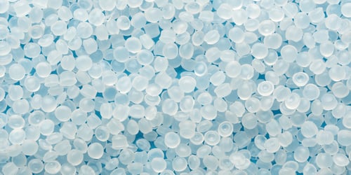 Preview: Translucent polymer pellets create clean blue banner background for recycling