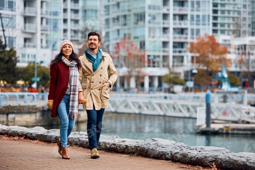 Preview: Happy couple enjoying in a walk along city quay.