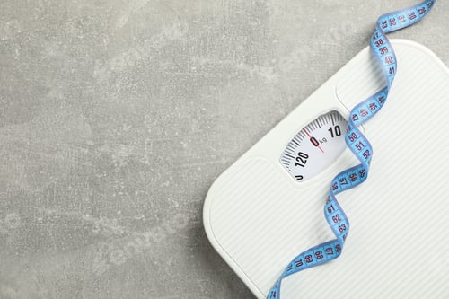 Preview: Scales and measuring tape on gray background. Weight loss concept