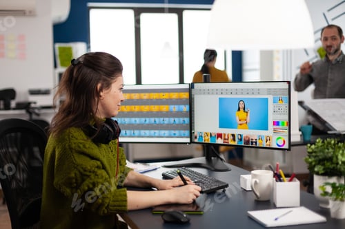 Preview: Retoucher woman editor working on computer with two monitors and stylus