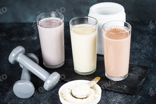 Preview: Protein cocktails and dumbbells, sport and fitness concept.