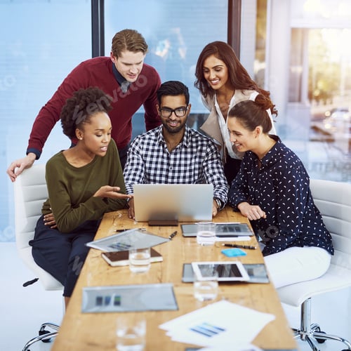 Preview: Shot of a group of designers discussing something on a laptop in the boardroom