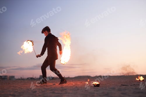 Preview: Male Fire Show Performer Dancing with Flames During Sunset