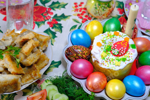 Preview: Ukrainian Easter festive dishes. Festive table setting. Bright colored eggs, cake Paska