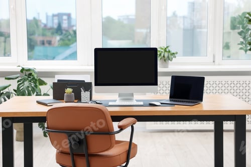 Preview: Stylish workplace with modern computer, laptop and stationery on wooden desk indoors