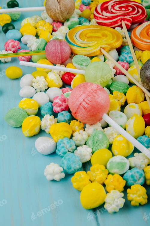 Preview: side view of colorful lollipops on candies in multi-colored glaze background