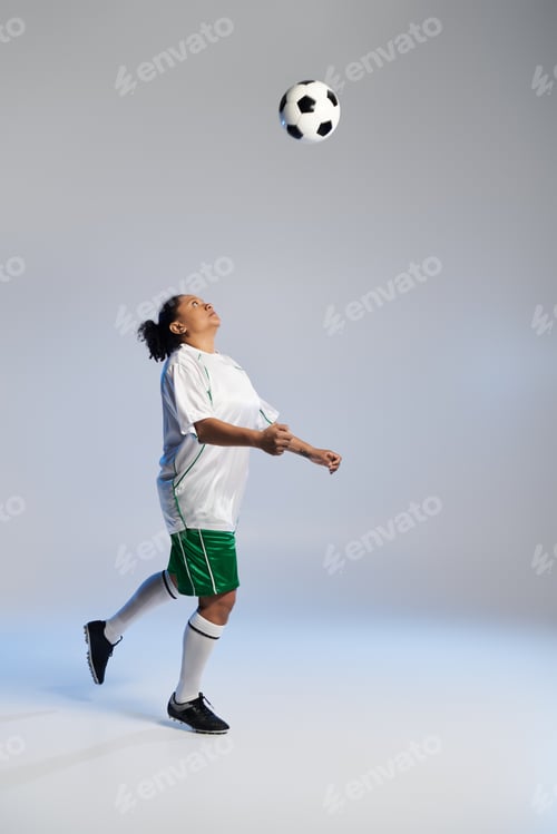 Preview: Athletic Woman Heads A Soccer Ball