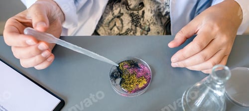 Preview: Female scientist adding drop of liquid from from pipette over petri dish with mix of glitters in lab
