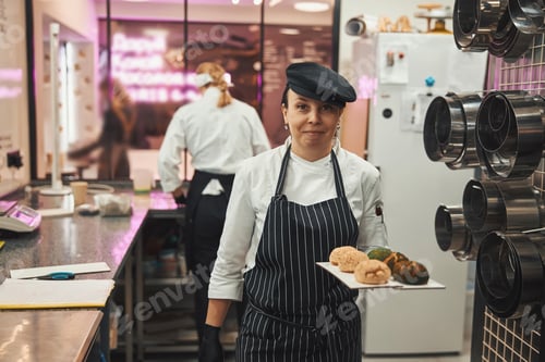 Preview: Talented female confectioner posing with tasty treats