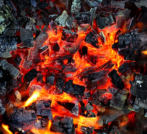Glowing Hot Coal Embers and Charred Wood