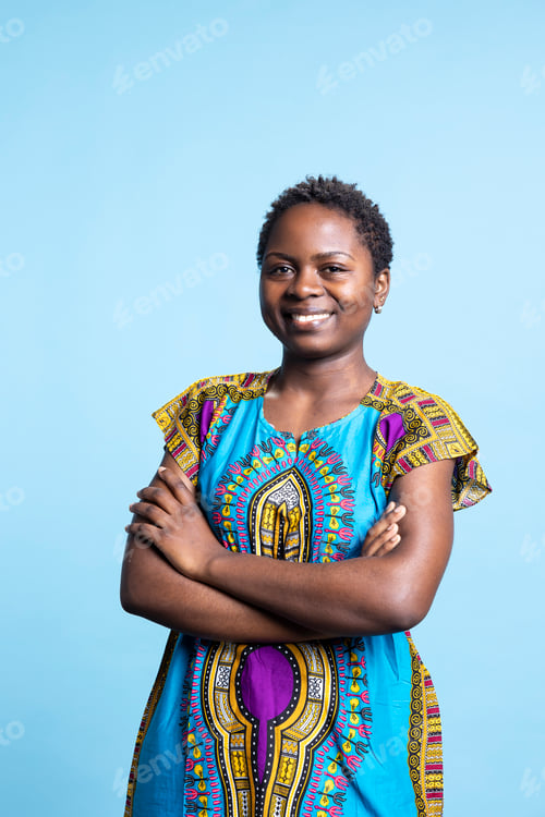 Preview: Portrait of cheerful woman standing with arms crossed on camera