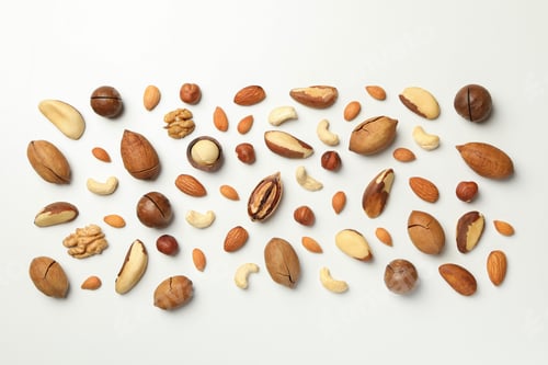 Preview: Different tasty nuts on white background, top view