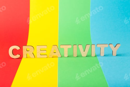 Preview: Wooden letters form word creativity on colorful background