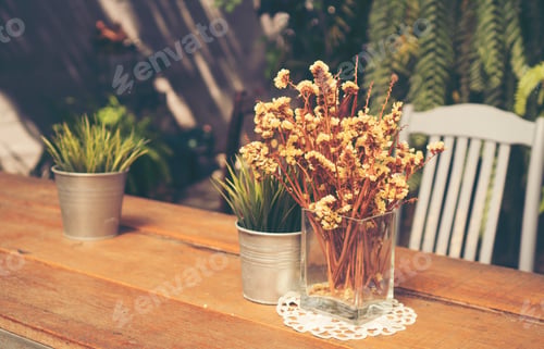 Preview: dry yellow flower on table in the cafe, vintage filter image