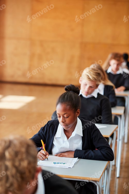 Preview: Teenage Students In Uniform Sitting Examination In School Hall