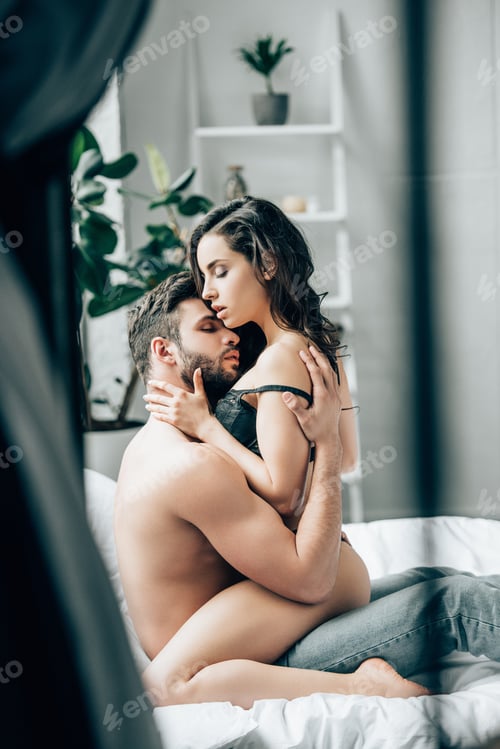Preview: selective focus of shirtless man touching attractive brunette girl in underwear