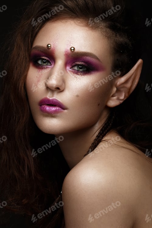 Preview: Brunette girl with a creative hairstyle braids, art make-up and the elf's ears. Beauty face.