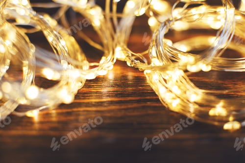 Preview: christmas beautifull shiny gold garland on a wooden brown background. sparkle festive background