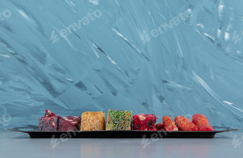Preview: Tray full of appetizing Turkish delight on the blue background