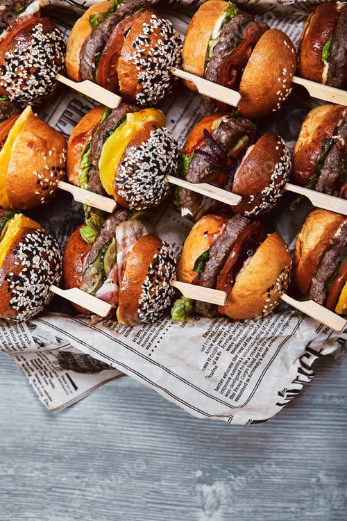 Preview: Big set of many hamburgers. Top view, cheesrubogers beautifully laid out on a tray. Seth fast food