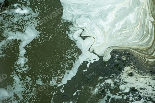 Preview: Black water with white bubbles in the waste water treatment pond