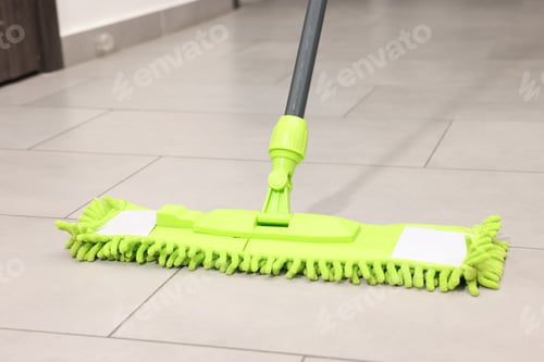 Preview: Cleaning floor with bright microfiber mop indoors