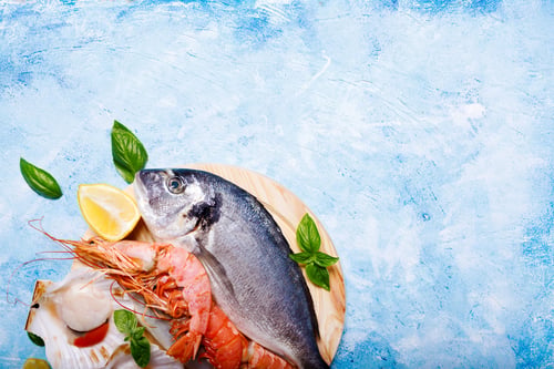 Preview: Food background with sea fish on blue.