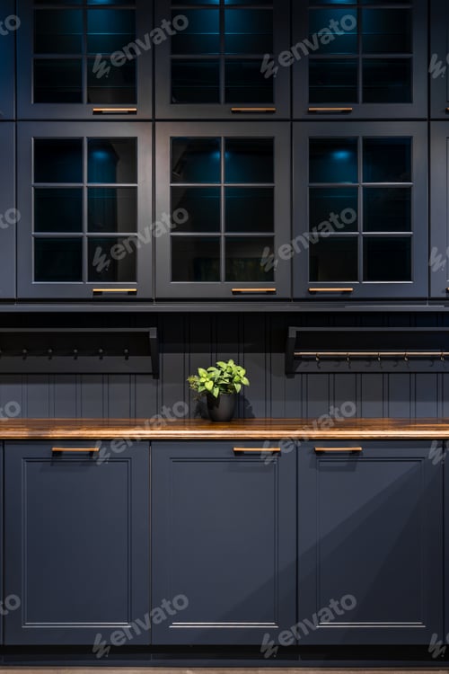 Preview: Dark blue kitchen cabinets with glass showcases. Modern design with wooden countertop and lighting.