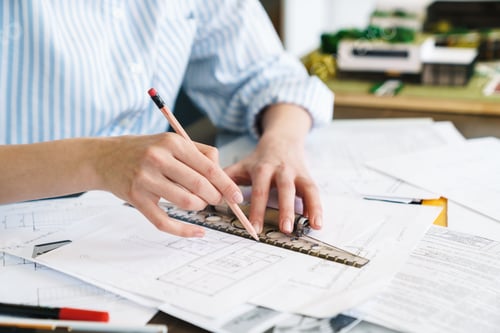 Preview: Cropped photo of woman architect making drawing while designing draft