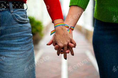 Preview: close-up of two lgtbi women holding hands on the street