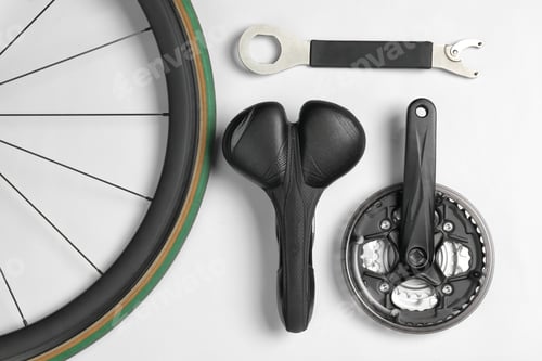 Preview: Set of different bicycle parts and tool on white background, flat lay