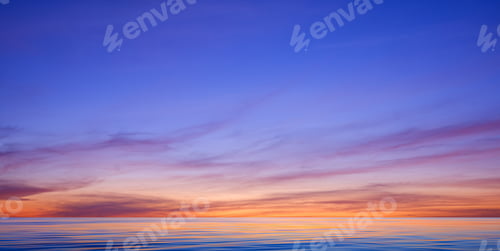 Preview: Idyllic sunset sky background over sea with motion blur of flowing water surface in panoramic view