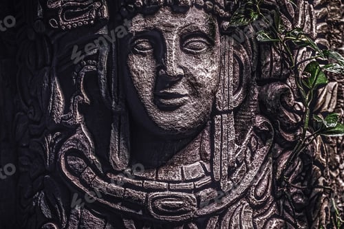 Preview: Beautiful rocky monument with a carved image of a human face in the jungle