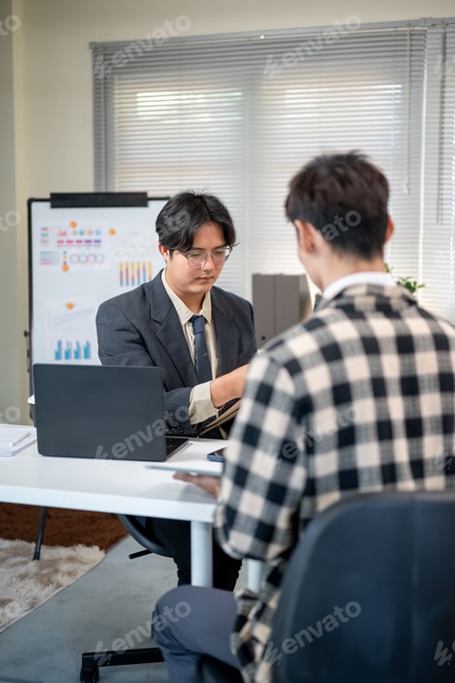 Preview: Glasses asian businessman meet with a coworker or employee at working table in company's office.