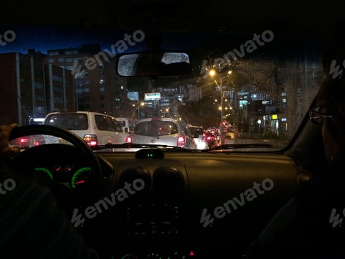 Preview: Stuck in traffic while driving at nighttime in the city during rush hour