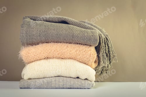 Preview: Stack of cozy knitted sweaters