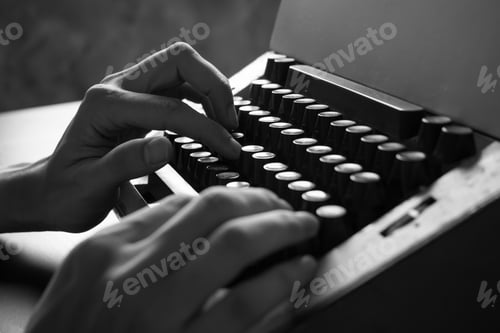 Preview: Close up of Male hands typing on the old typewriter. Black and White tone