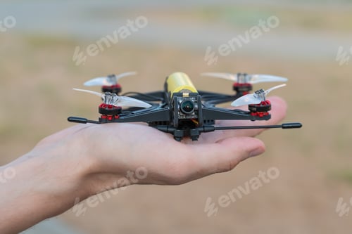 Preview: Safe quadcopter landing on the pilot's palm closeup. Man holding drone in his hand close up