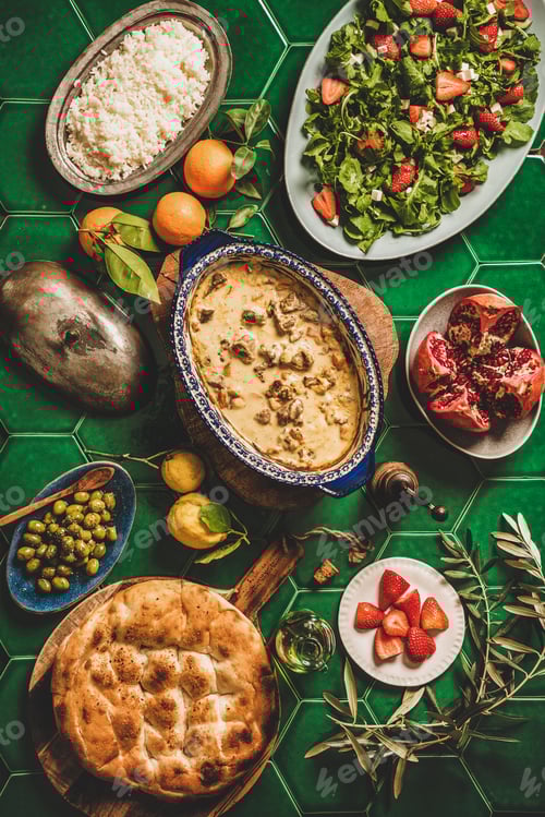Preview: Flat-lay of Turkish dinner with lamb, pilav, salad and flatbread
